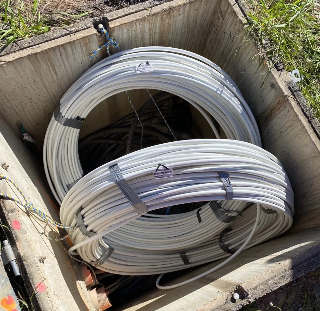 Telecommunications cable coils in a pit